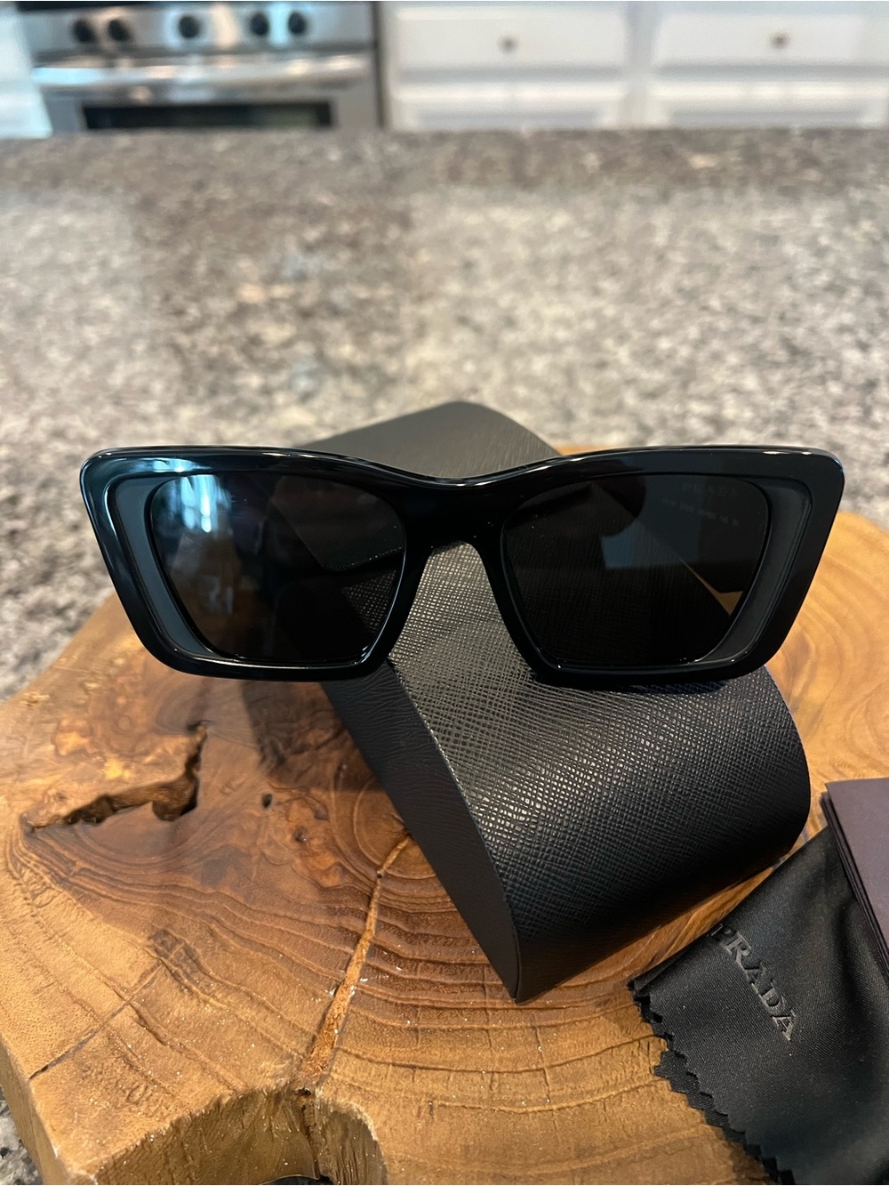 Prada Women’s Black Cat-Eye Sunglasses with Dark Lenses